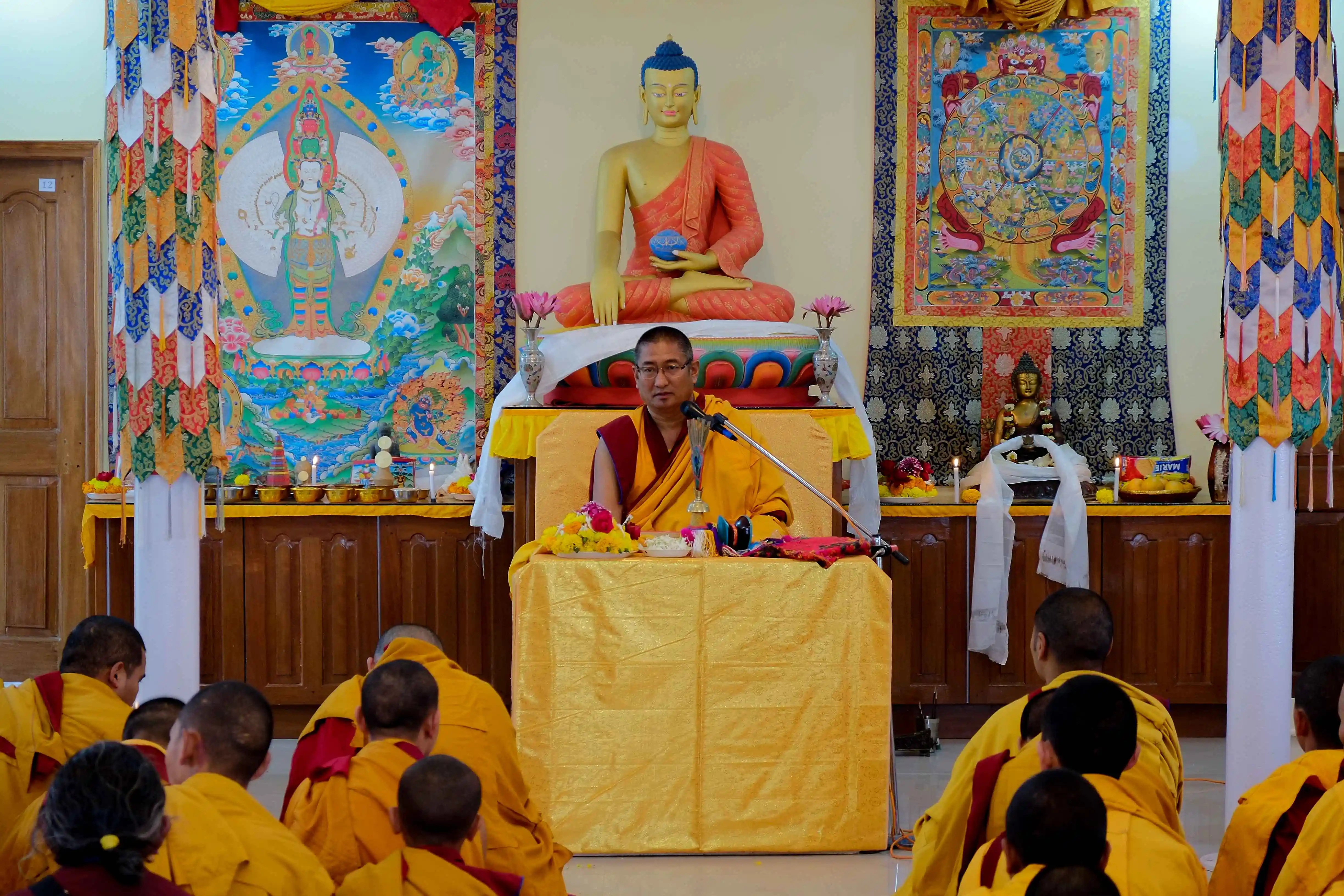 A monk teaching in a monastery setting